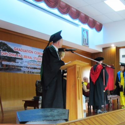 A refugee student receiving her diploma